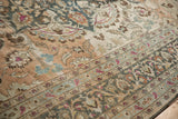 Close-up on the heavy abrash and low pile of a distressed Persian carpet's vine and palmette border.