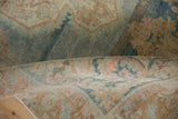 Distressed pile texture and muted colors of a rolled vintage Persian Arak rug.