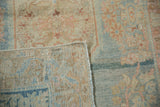 Distressed Arak rug: faded sky blue, rose floral pattern, abrashed ground, and hand-knotted back.