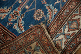 Close-up of a vintage Persian rug's folded corner showing the detailed border and hand-knotted foundation.