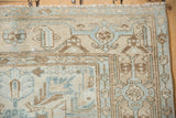 Distressed Malayer rug corner, geometric floral botehs, turtle samovar border in ivory, blue, and brown.