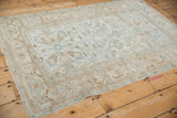 Distressed Malayer rug detail: unique turtle samovar border with pale blue floral motifs.