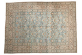 Distressed vintage Khorassan carpet with dusty blue field, intricate scrolling floral vines.