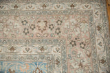 Distressed vintage Khorassan rug corner, faded floral field and dusty sapphire blue design.