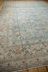Muted floral border of distressed Khorassan rug with scrolling vines and machine-bound edge.