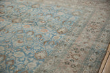 Dusty sapphire blue field with scrolling tendrils meeting the floral bouquet main border.