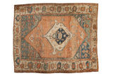 Antique Serapi carpet with a navy center medallion, an abrashed sandalwood field, and dusty blue corner spandrels.