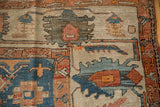 Knot heads and foundation visible through the low pile of an antique Serapi's geometric design.