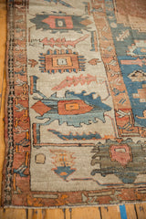 Hand-knotted texture showing visible knot heads and primitive serrated leaves on an antique Serapi carpet.