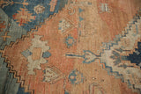 Storied texture of a hand-knotted Serapi carpet with low pile, exposed foundation, and serrated motifs.