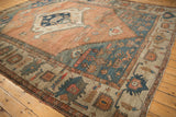 Antique Serapi carpet with bold blue spandrels and a central medallion on an abrashed field.