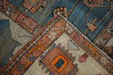 The hand-knotted construction and side cord selvage of an antique Serapi carpet corner.