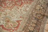 Evenly worn pile on the corner spandrel and main border of a distressed antique Persian carpet.