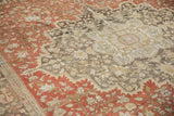 Striking color abrash from chestnut to charcoal across the floral field of a distressed antique rug.