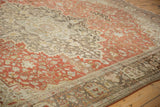 Angled view of the distressed Persian rug showing color abrashes across the low-pile floral design.