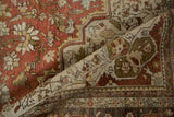 Close view of the worn pile on a distressed Farahan Sarouk revealing intricate floral borders.