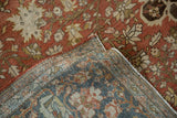 Corner view of a distressed Farahan Sarouk rug showing the low pile and hand-knotted reverse.