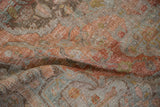 Distressed Malayer rug's worn texture, with terracotta, slate blue, and visible foundation weave.