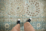A close view of the distressed Tabriz carpet's low pile and mostly even wear across the knot heads.