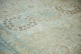 Detailed view of the distressed texture and woven palmette patterns on a vintage Tabriz.
