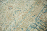 Evenly worn pile on a vintage Tabriz carpet showing beige and dusty blue floral motifs.