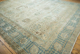 Low pile texture and dusty blue weeping willow border of a distressed vintage Tabriz rug.