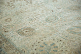 Low pile texture of a distressed Persian Tabriz carpet with dusty blue and beige palmette details.