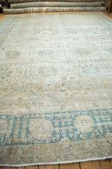 Ground-level view highlighting the distressed pile and muted colors of a vintage Tabriz carpet.