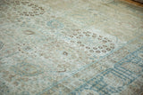 Visible knot heads and mostly even wear on a vintage Tabriz rug with dusty blue palmettes.