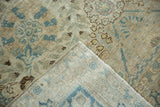 Corner detail of a vintage Tabriz showing the distressed, low pile and hand-knotted back.