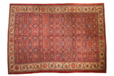 Vintage Mahal carpet with an allover vine design in brick red and sapphire blue with a wide sand-colored border.