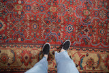 Low-pile texture of a vintage Mahal carpet with brick-red and sapphire-blue interconnected floral vines.