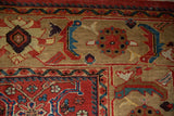 Herati and palmette motifs in sapphire blue and brick red on the sand-colored main border.