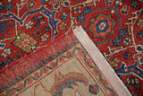 A view of the vintage Mahal carpet's corner showing its hand-knotted back and secured side cord.