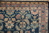 Vintage Persian Lilihan rug corner with cobalt blue Herati field and dusty blush floral vine border.