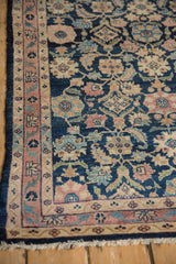 Hand-knotted Lilihan rug corner with dusty blush meandering vine border and fringe.