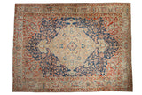 Vintage Baktiari carpet with a large diamond medallion on an indigo blue field with red floral spandrels.