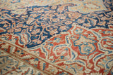 Close-up of the distressed weave showing indigo floral patterns and red scrolling border designs.