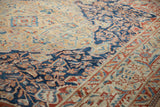 Decorative texture of a distressed Baktiari carpet showing low pile with sand and indigo floral details.