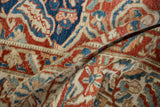 Soft fold showing the distressed texture and hand-knotted weave of a vintage Baktiari carpet.