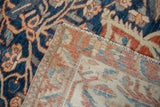 Corner detail of a vintage Baktiari carpet showing the back weave and machine-bound edge.
