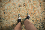 Distressed vintage Khorassan carpet showing worn pile texture in terracotta, ivory, and dusty blue.