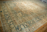 Distressed Khorassan rug border with meandering palmette blossoms and signature cartouche in faded tones.