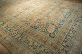 Distressed corner of vintage Khorassan carpet, showing palmette border and field arabesques in muted tones.