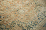 Aged texture of a distressed Khorassan carpet, showcasing faded botanical motifs in terracotta and blue.