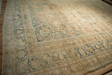 Distressed corner of Khorassan carpet with faded terracotta, teal blue palmette border.