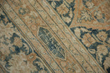 Distressed vintage Khorassan carpet pile showing faded dusty blue and sandalwood botanical motifs.