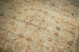 Distressed vintage Khorassan carpet with faded terracotta, ivory, and dusty blue arabesque patterns.