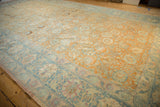 Angled view showcasing the mostly even wear on the vintage Tabriz carpet's terracotta and sky blue pile.