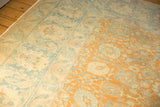 Evenly worn pile on a distressed Tabriz carpet in terracotta, ivory, and dusty blue.